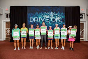 Rachel Rohanna, a 2021 Epson Tour graduate and the first mom to graduate, accepts her LPGA card with daughter Gemelia.